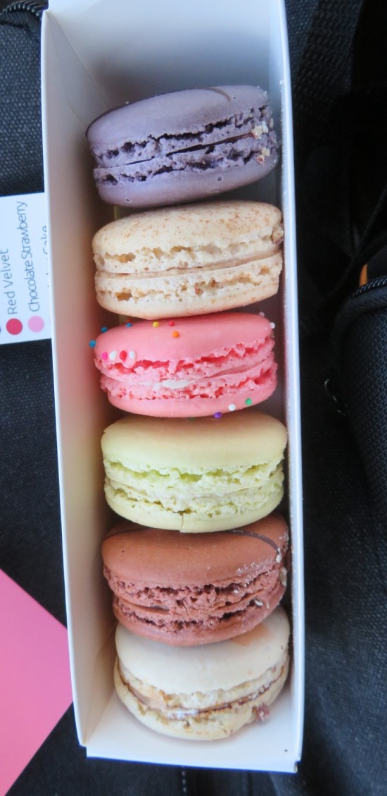 Six macarons in a long box.