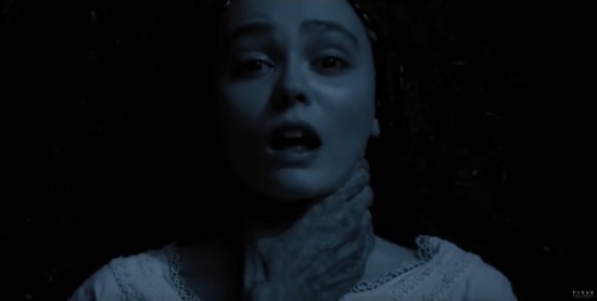 Young 19th-century woman's frightened face in darkness, with gnarly vampire hand around her neck.