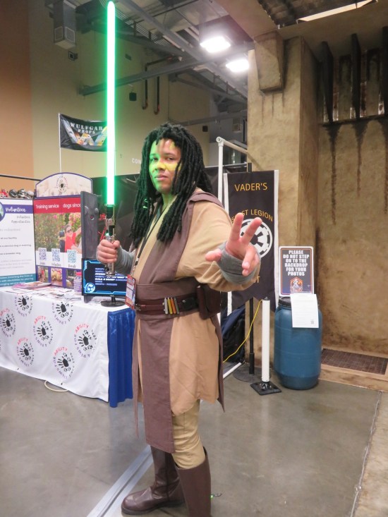 costume: Jedi Quinlan Vos with green lightsaber.