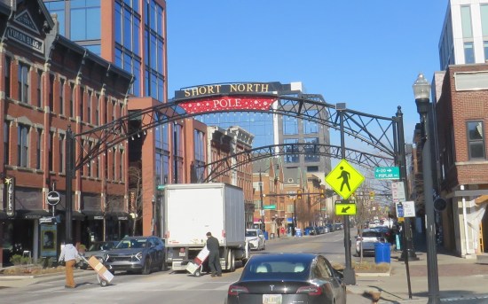 Archway over street leading through the Short North neighborhood, modified to read "Short North Pole" in Christmas colors. A deliver truck is stopped right underneath the arch, muddying the shot.