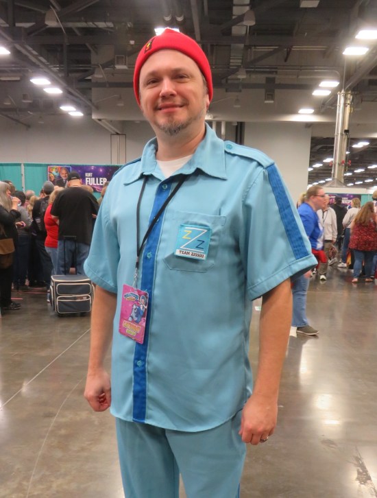 costume: baby blue buttoned shirt, matching pants, red cap and Team Zissou badge.