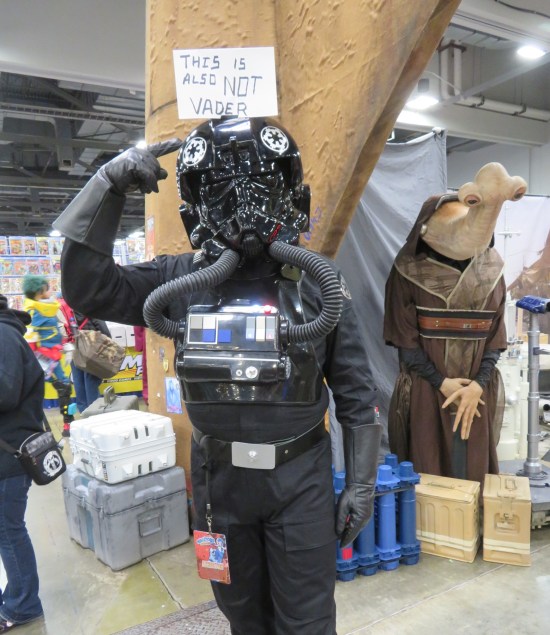 costume: TIE Fighter Pilot with handwritten sign on his head, "This is also not Vader."