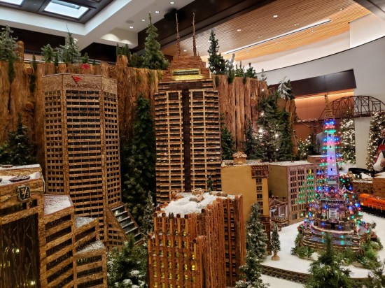 Intricate wood models of downtown Indianapolis buildings including the OneAmerica Tower, Salesforce Tower, and Monument Circle featuring the lit-up Soldiers and Sailors Monument.