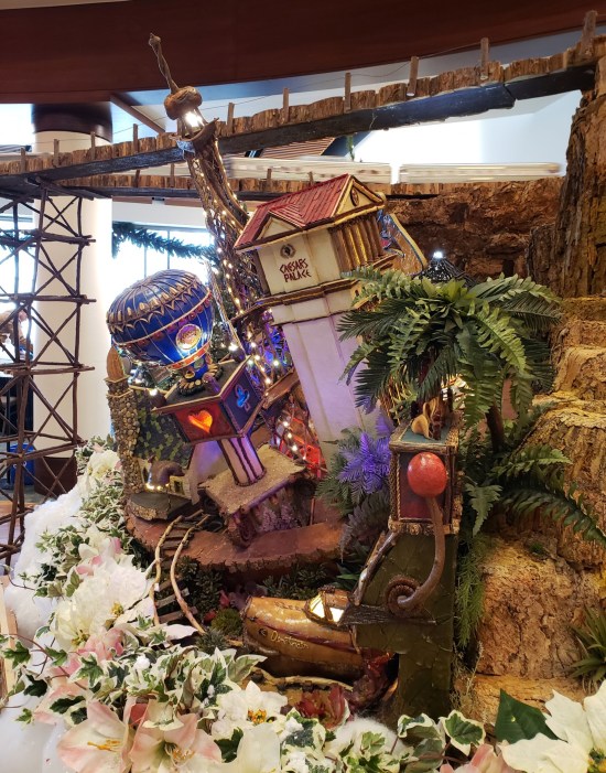 Intricate wood model of Vegas slot machine and Caesar's Palace Casino.