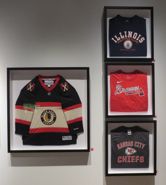 A Chicago Blackhawks jersey and three T-shirts for the Atlanta Braves, the Kansas City Chiefs, and the University of Illinois Urbana-Champaign's Fighting Illini.