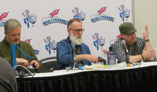 Same three artists, same table. Cory Smith is talking; Thom Zahler and Dave Wachter are preparing their tools.