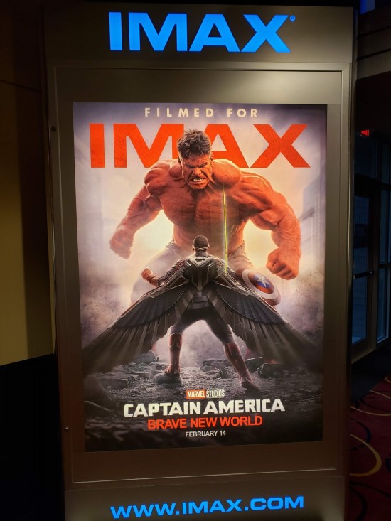 IMAX lobby poster of Red Hulk towering menacingly over Anthony Mackie's Captain America.