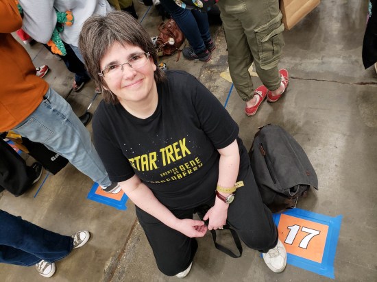A smiling Anne sitting at the end of row 17 on a collapsible stool she'd brought along.