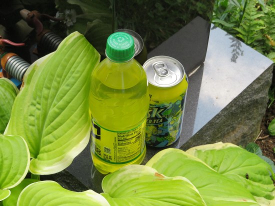 Drinks set at the foot of Varney's tombstone -- two bottles plus a can of Lipton Brisk Iced Tea.