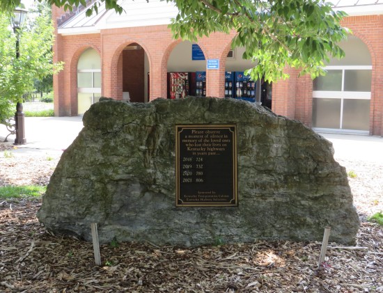Rock with a plaque listing total Kentucky highway deaths each year from 2018 to 2021.