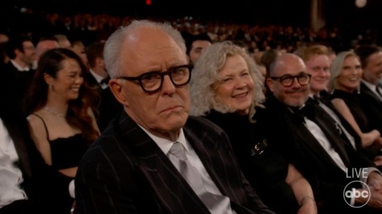 John Lithgow at the Oscars, staring into the camera, disappointed.
