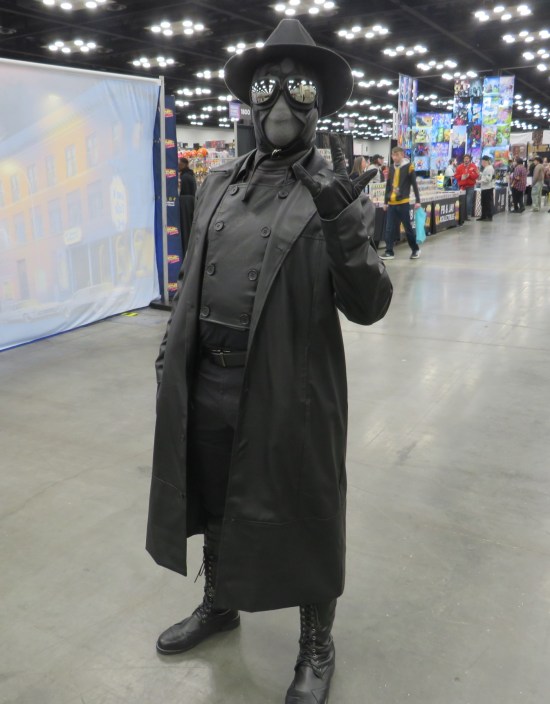 cosplay: Spider-Man Noir throwing a devil-horns gesture.