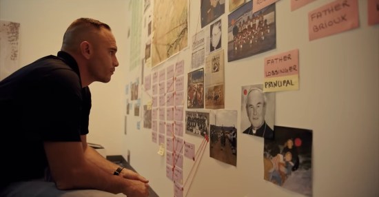 A detective sits at an evidence board diagramming the deaths at an Indian residential school.