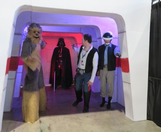 Fan-made Death Star hallway with cosplayers as Vader, Chewbacca, Han Solo, and an Alderaanian consular security guard.