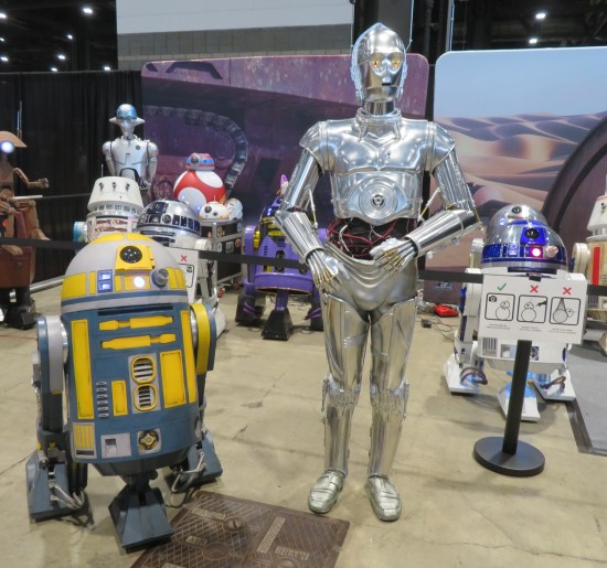 Collection of fan-made Star Wars droids exhibited on the show floor.
