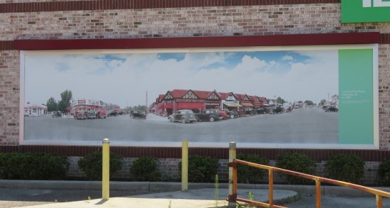 Large outdoor painting of old-timey main streets with quaint shops.