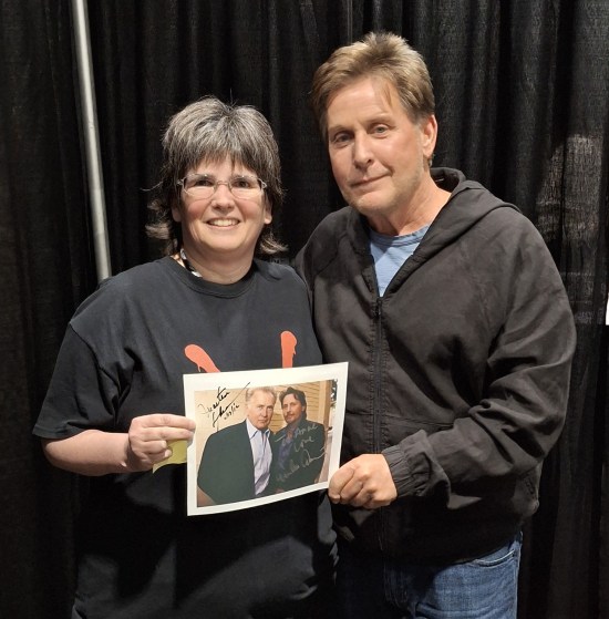 Estevez and Anne, both holding an 8-x-10 photo of him with Martin Sheen, who'd autographed it years ago.