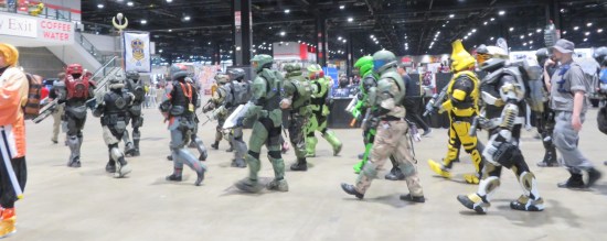 Parade of Halo armored cosplayers marching through the exhibit hall.