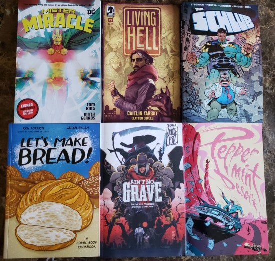 Six comics on a table: Ain't No Grave, Living Hell, The Schlub, Let's Make Bread!, Mister Miracle, and Peppermint Desert.