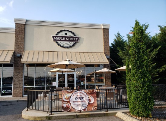 Maple Street Biscuit Company at the end of a strip mall. Nifty patio furniture and very tall, thin shrubs.