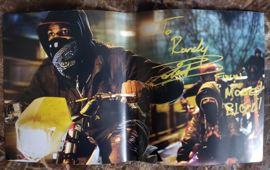 Where John Boyega signed next to the pic of him as Moses on motorbike.