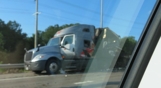 Blurry pic of the silver cab at the front of the burned trailer, still attached but somehow not melted down.