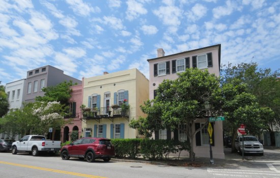 Rainbow Row houses in white, gray, pink, jaundice, and fuchsia.