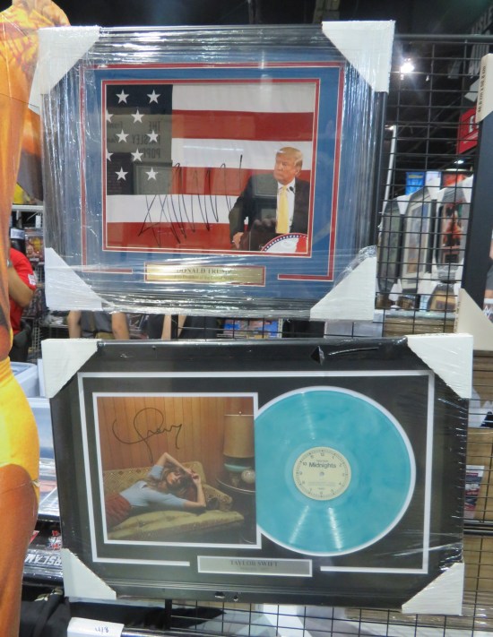 Two framed autographs sharing the same booth wall: Donald Trump's and Taylor Swift's.