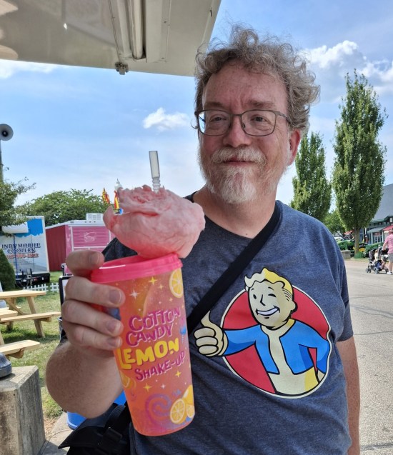 Me holding a giant plastic cup labeled "Cotton Candy Lemon Shake-Up" with lemonade in it.