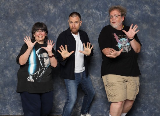Us doing jazz hands with Ewan McGregor who has a buzzcut, beard and mustache.
