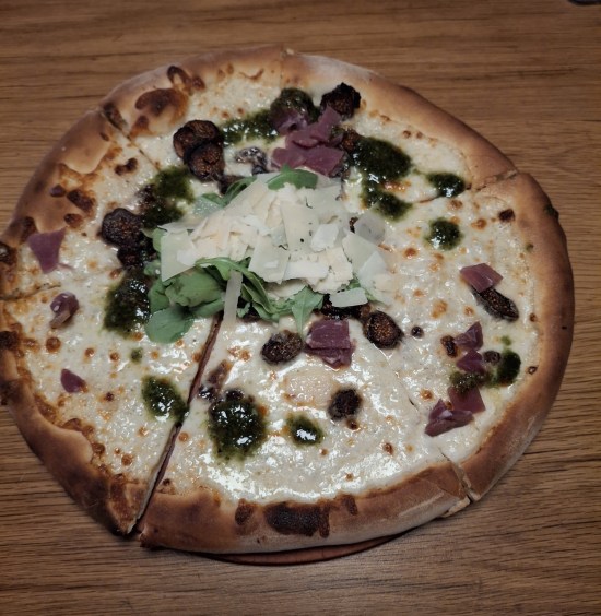Pizza on wooden serving board.