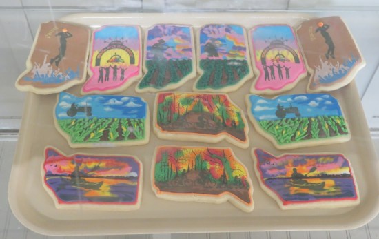 Tray of cookies with iced pics of the Pacers, the fair, autumn forests, farmlands, and canoeing at sundown.