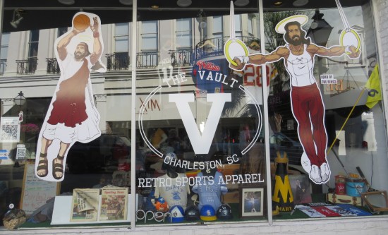 Sports wear shop with two drawings of Jesus on its windows: one attempting a basketball jump-shot and one with a halo in a sleeveless T-shirt hanging from two gymnastic rings.