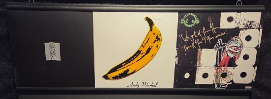 Albums by Joy Division, Velvet Underground, and A Tribe Called Quest hung together.