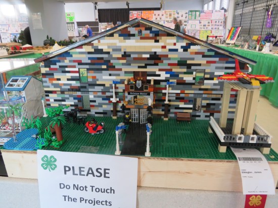 Lego mansion labeled Brixton Manor, made with bricks of random colors.