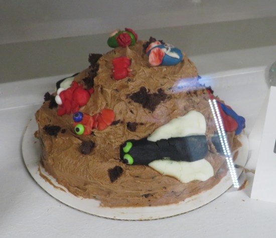 manure pile cake topped with edible insects.