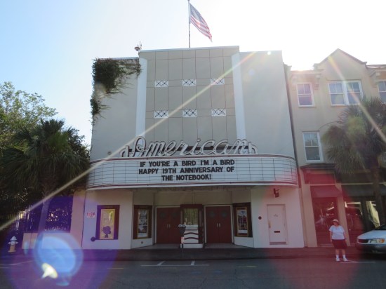 The American Theater is white and tall and its marquee says "If You're a Bird I'm a Bird. Happy 19th Anniversary of 'The Notebook'!"