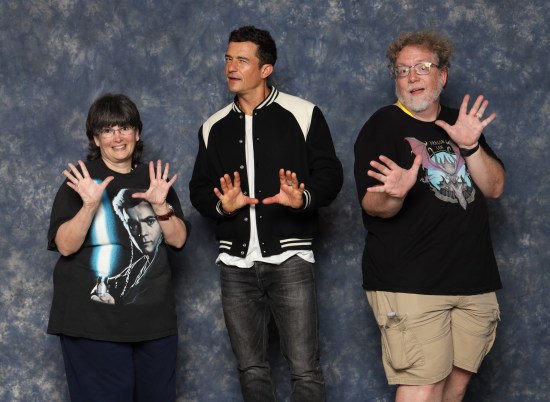 us doing jazz hands with a more reserved and skeptical Orlando Bloom.