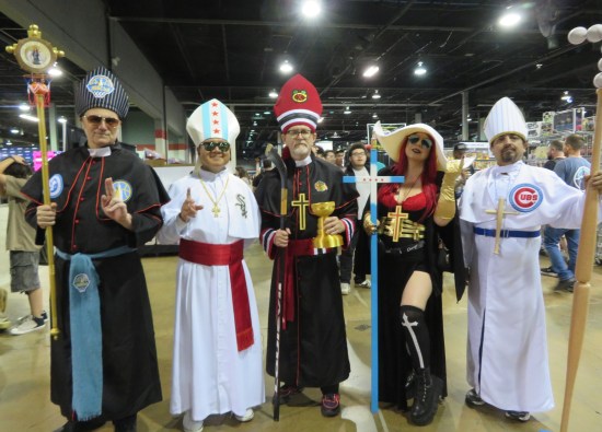 Five cosplayers in robes mixing Catholic and Chicago iconography.