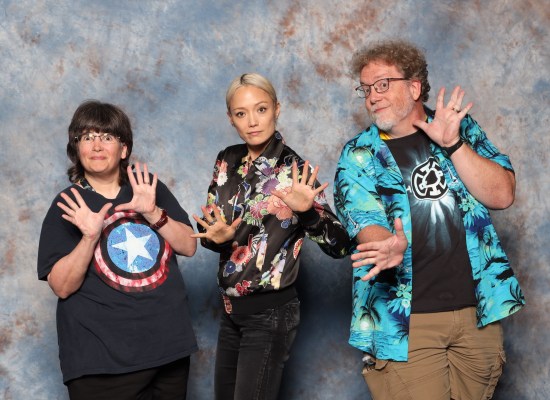 Us doing jazz hands with Pom Klementieff, who's in black jeans and a black flowery shirt.