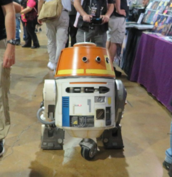 Remote-control R5-D4 in the middle of an aisle.