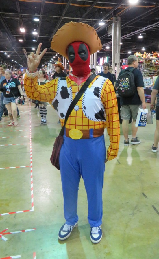 Sheriff Woody cosplayer with Deadpool mask.