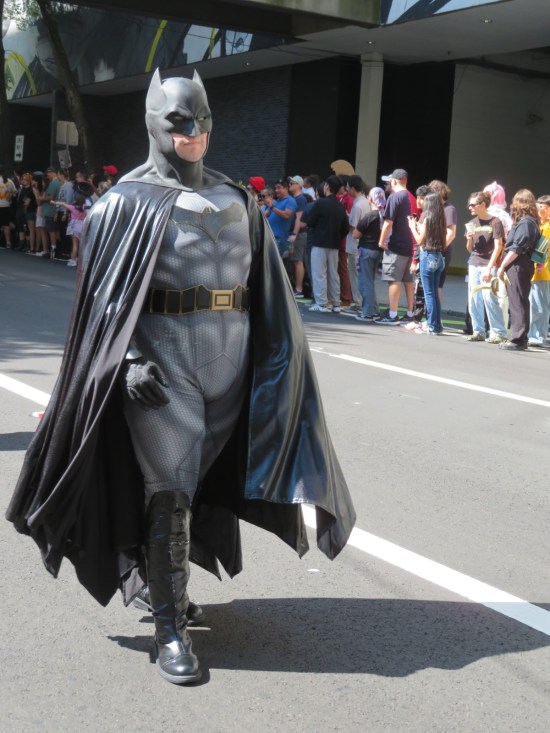 Batman cosplayer, marching proudly and sternly.