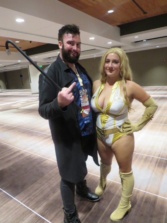 Billy Butcher and Starlight costumes in a very empty Marriott room with ugly brown striped carpet.