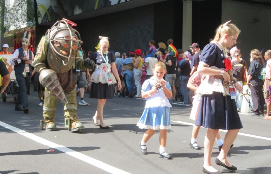 Three Bioshock Little Sisters cosplayers plus one armored Big Daddy monster.