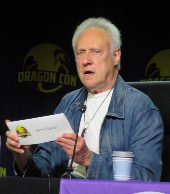 Brent Spiner looking at his name card with a dpery sort of face.