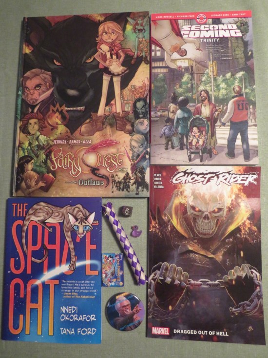 Four graphic novels by the aforementioned creators, a Severance finger-trap, a Marriott Marquis d6, a tiny purple rubber duckie, a Walton Goggins "Righteous Gemstones" button and a itsy-bitsy Disney card game.