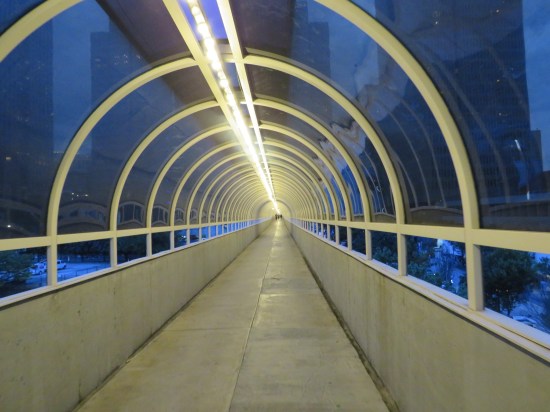 Inside a habitrail with blue tinted windows looking out upon downtown Atlanta.