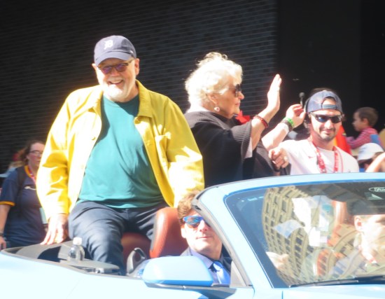 Dave Goelz and Bonnie Erickson riding in the back of a convertible and in too much sunlight.