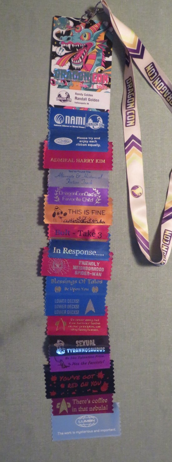 18 ribbons on a badge attached to a Dragon Con lanyard.